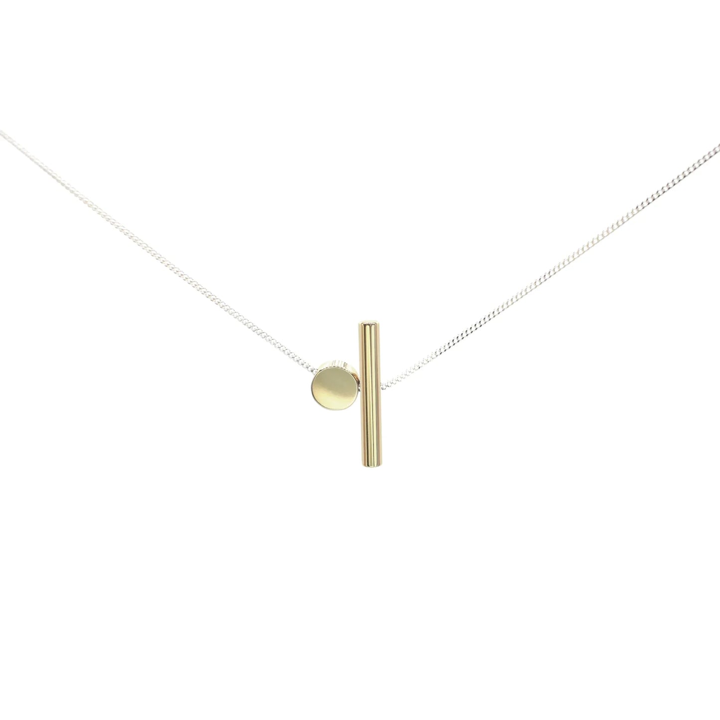 The Rock & A Hard Place Necklace is a minimalist mixed metal piece with a fine sterling silver chain, a small gold circle, and a vertical gold bar pendant—ideal for lovers of handmade jewelry.