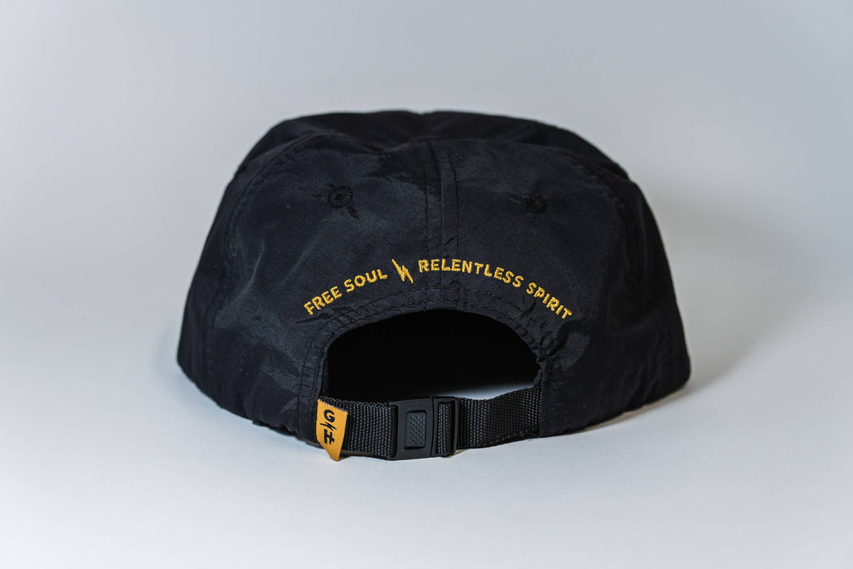 The Fearless 5-Panel Hat is black, shown from the back with "FREE SOUL \ RELENTLESS SPIRIT" embroidered in yellow above an adjustable strap and features a small yellow tag—classic Gritty Habits style.