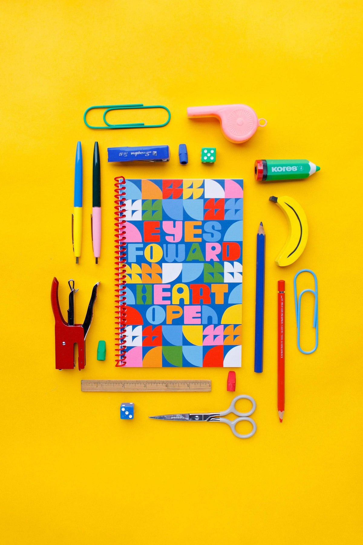 The Eyes Forward, Heart Open Journal features an original illustration on a bright yellow cover, surrounded by colorful school supplies like pens, pencils, erasers, scissors, ruler, whistle, and paper clips.