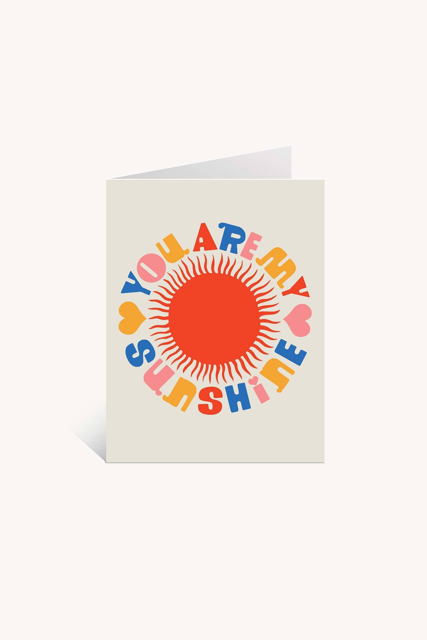 The You Are My Sunshine Greeting Card by Lisa Congdon features a large red sun, colorful YOU ARE MY SUNSHINE text, and orange-yellow hearts on a cream background. Blank inside—perfect for any heartfelt message.