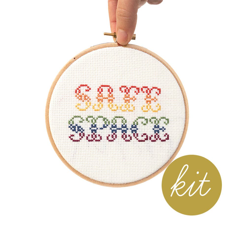 Cross-stitched hoop with 'Safe Space' text and 'kit' label on a white background