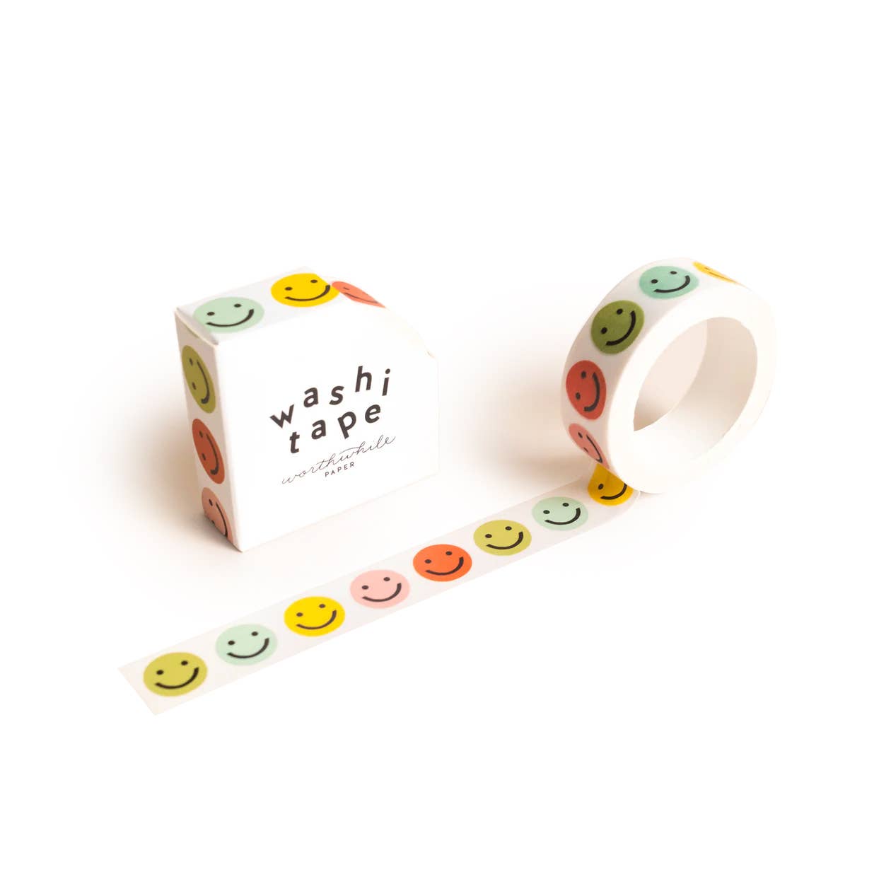 Smiley Face Washi Tape comes in eco-friendly packaging, both decorated with vibrant pink, yellow, orange, and green smiley faces on white. The repeating playful pattern brightens any project as the tape is unrolled.