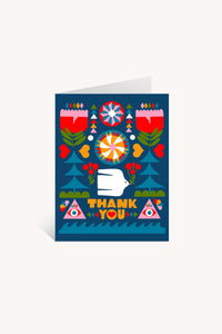 The Folk Flowers Thank You Greeting Card by Lisa Congdon features floral and geometric folk art, a white hand, red hearts, two eyes in triangles, and bold yellow “THANK YOU” letters on a deep blue background.