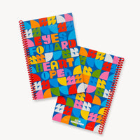 The Eyes Forward, Heart Open Journal features bold geometric designs in vibrant blue, pink, red, yellow, orange, and green. Its cover displays the inspiring "EYES FORWARD HEART OPEN" message—perfect for use as a sketchbook or blank notebook.