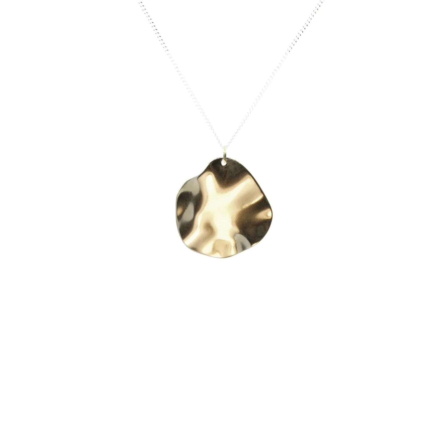 The Autumn Leaf Necklace is a delicate handmade silver necklace with a shiny, polished gold pendant in an irregular shape—a stunning mixed-metal piece displayed on a plain white background.