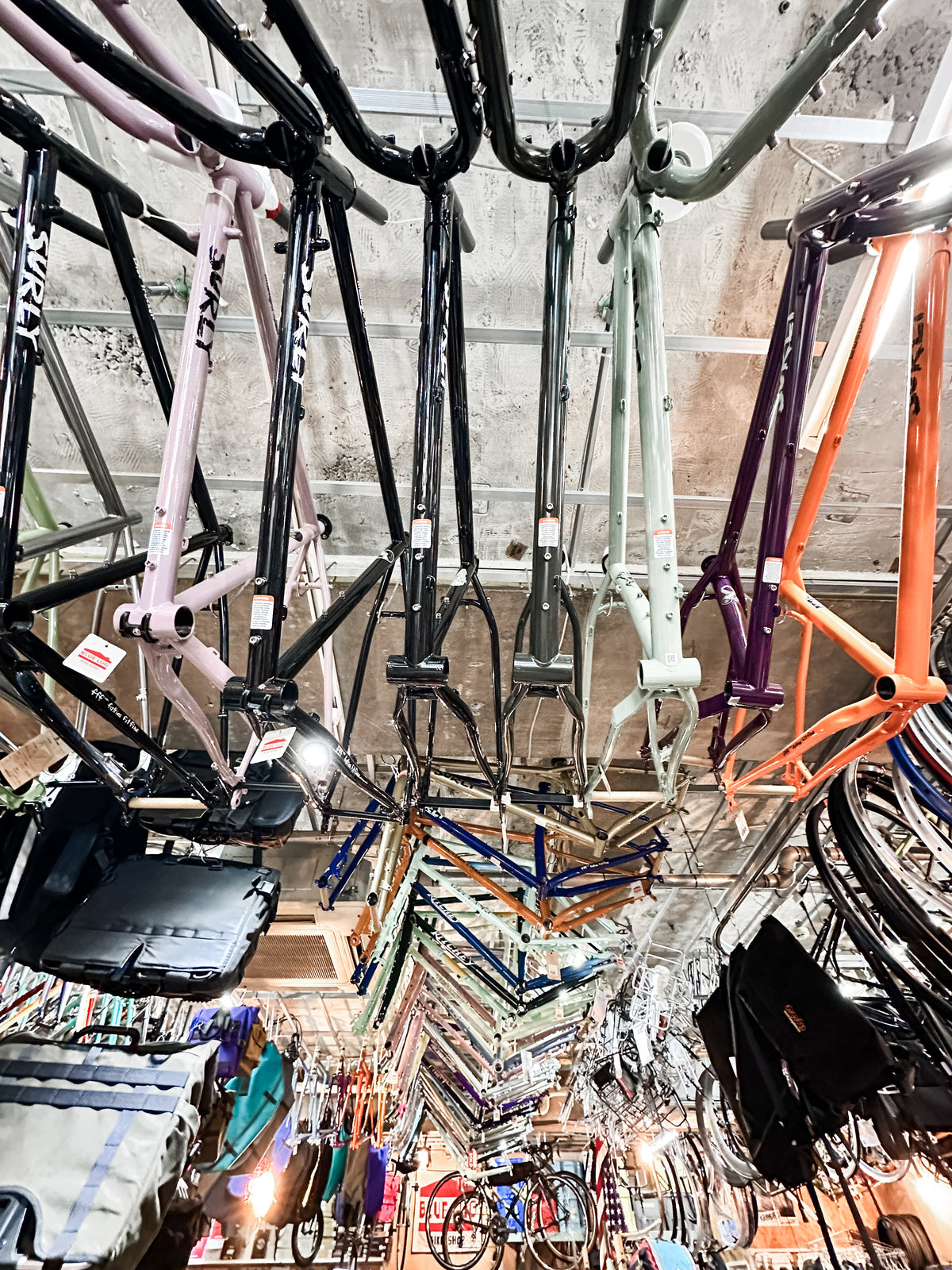 Japanese Mystery Boxes hang from the ceiling of the shop, surrounded by unique gifts and other treasures—perfect travel souvenirs for cycling enthusiasts and collectors alike.