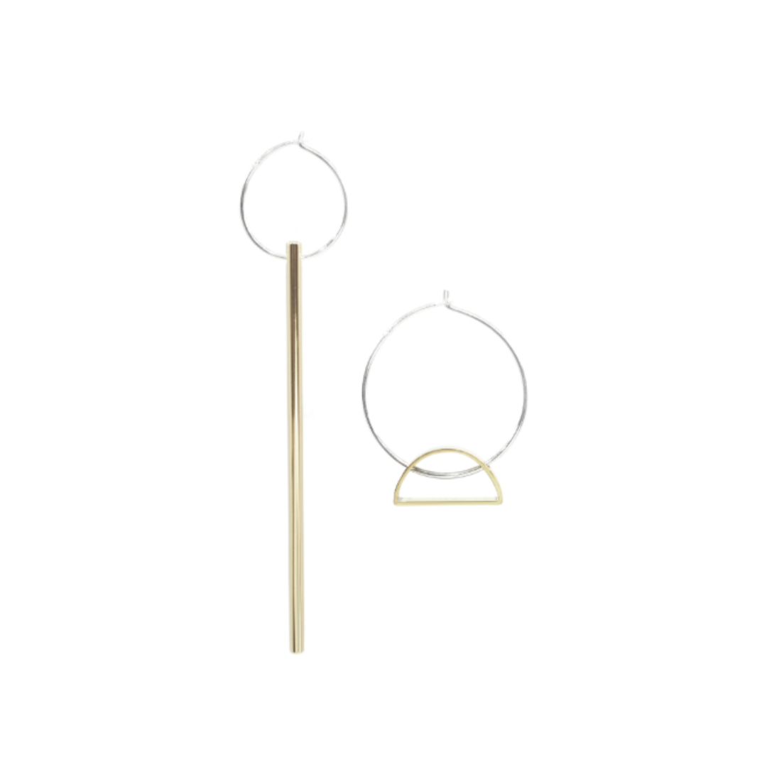 The Falling Light & Setting Sun Earrings feature two mismatched mixed-metal designs: a long vertical gold bar on a silver hoop, and a silver hoop with a small gold semicircle. Unique Cape Town jewelry displayed on a white background.