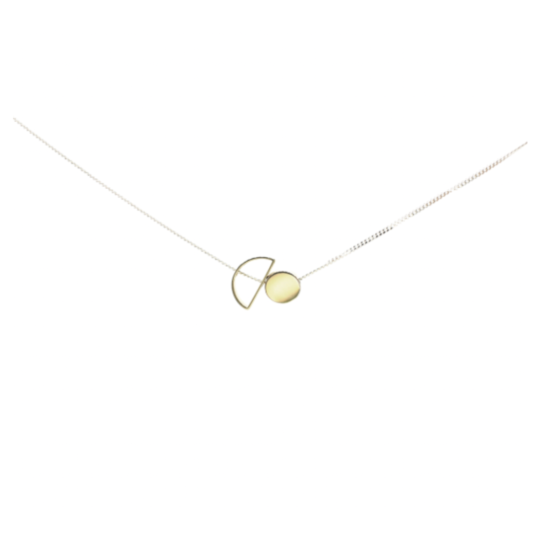 The Sun & Moon Necklace is a delicate mixed metal piece with a thin chain and minimalist geometric pendant—featuring a gold circle intersected by a gold semicircle—handcrafted in South Africa.
