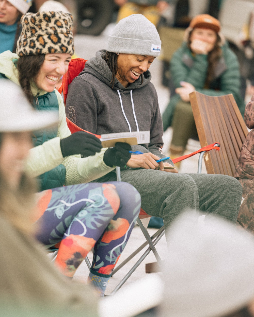 Friends laughing together while drawing outdoors at a Far Out retreat
