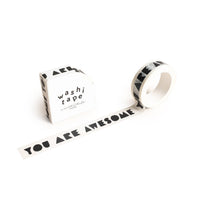 The You Are Awesome Washi Tape, featuring bold black hand-lettered text, is shown beside its packaging labeled "washi tape" on a white background.